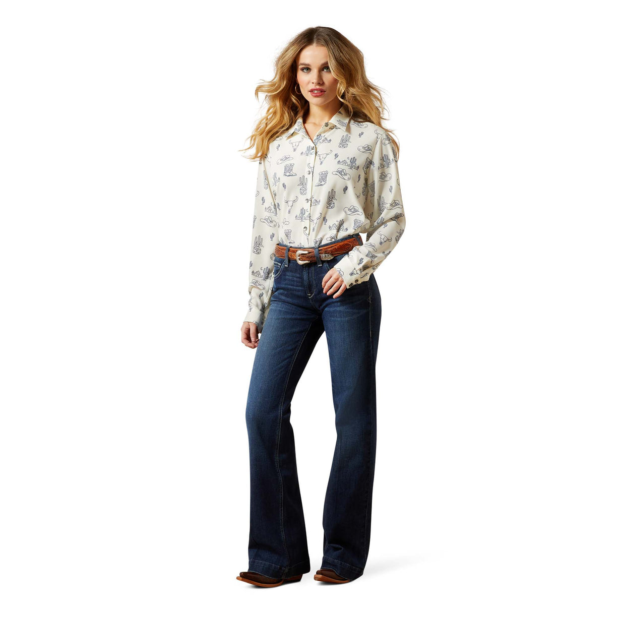 Woman wearing a patterned blouse and blue jeans on a white background