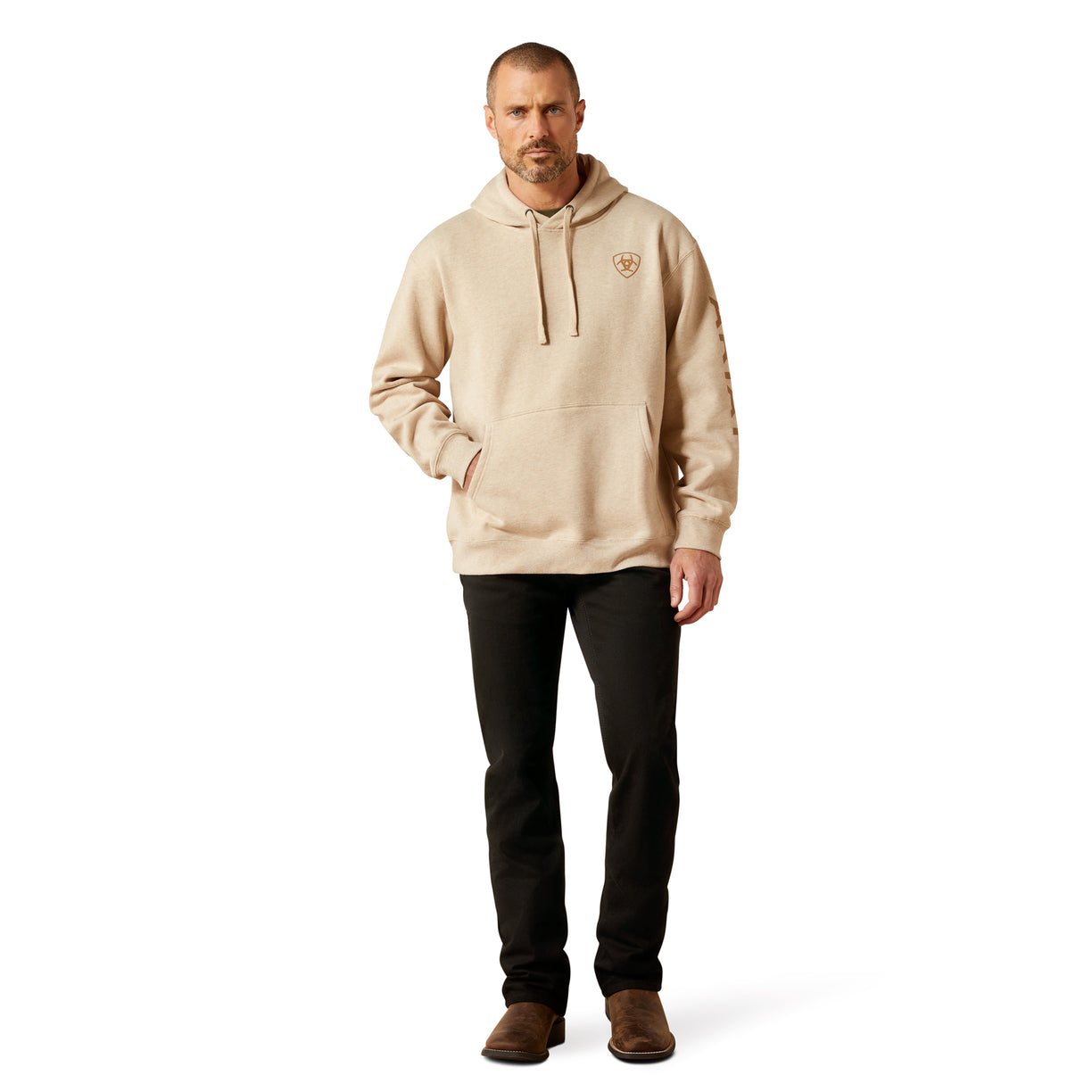 Man wearing a beige hoodie and black pants on a white background