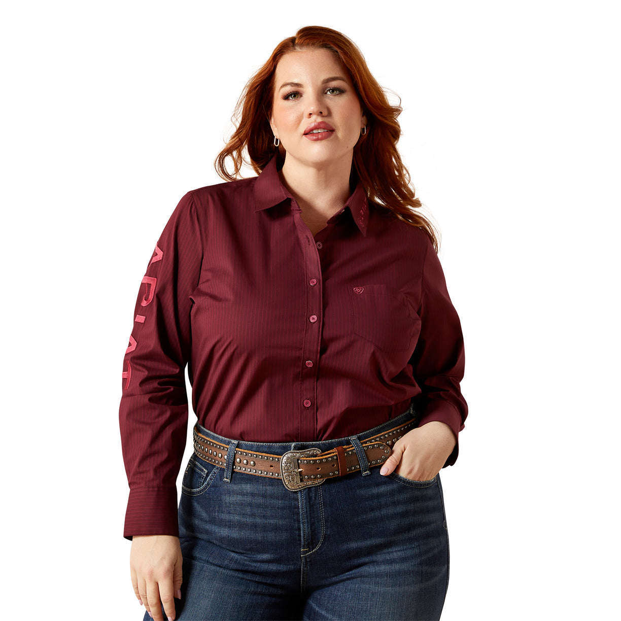 Woman wearing a maroon shirt with embroidered designs on a white background