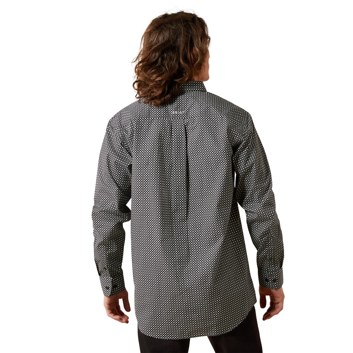 Person wearing a long-sleeve patterned shirt on a white background