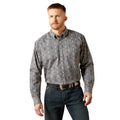 Man wearing a patterned shirt and jeans on a white background