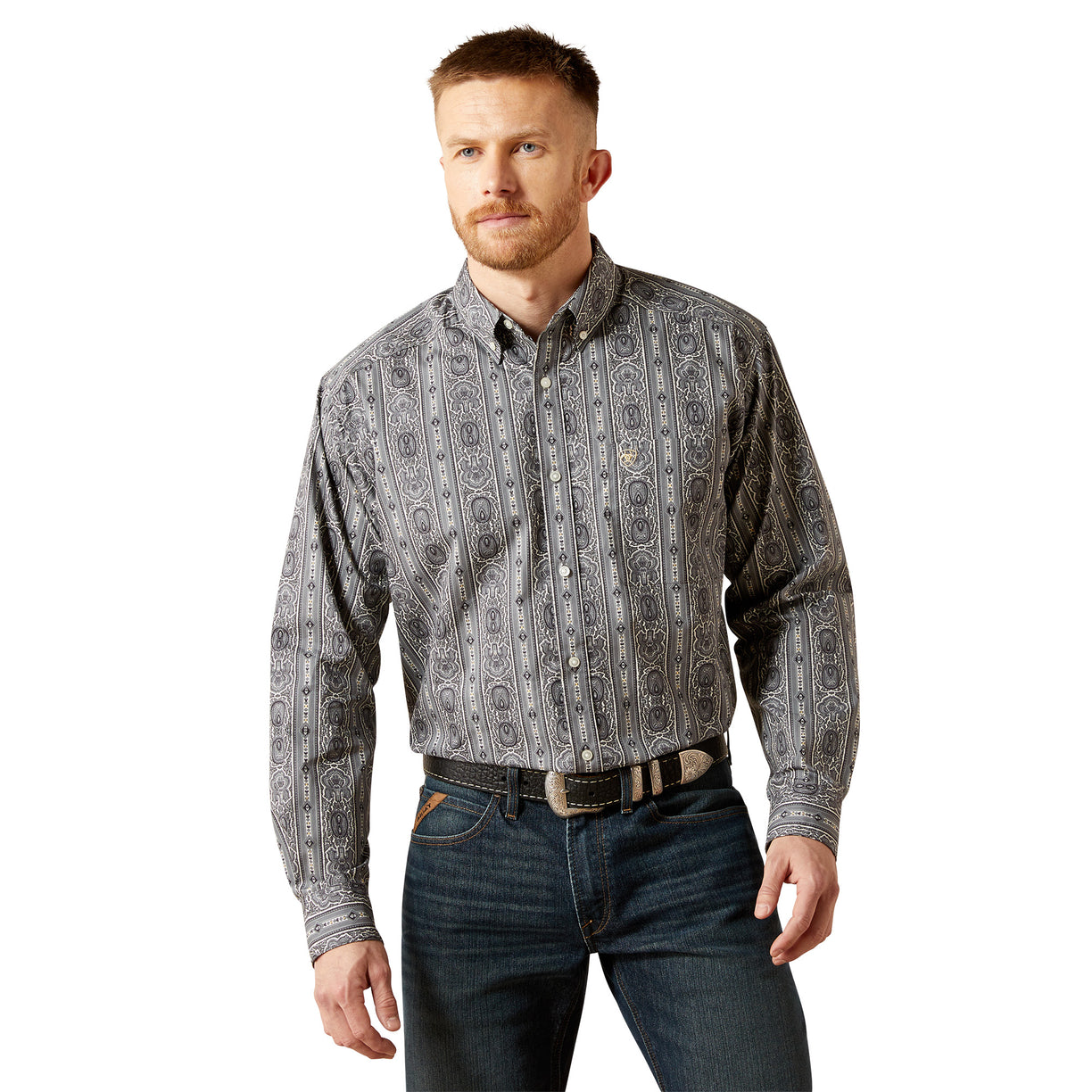 Man wearing a patterned shirt and jeans on a white background