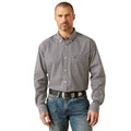 Man wearing a patterned shirt and jeans on a white background