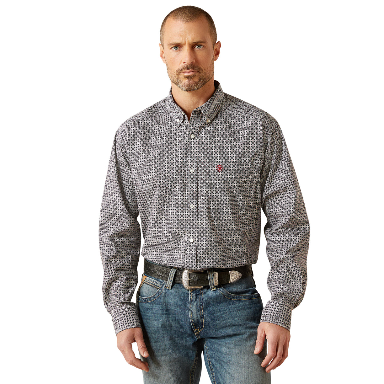 Man wearing a patterned shirt and jeans on a white background