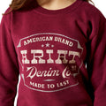 Red sweatshirt with 'American Brand Ariat Denim Co. Made to Last' text on a white background