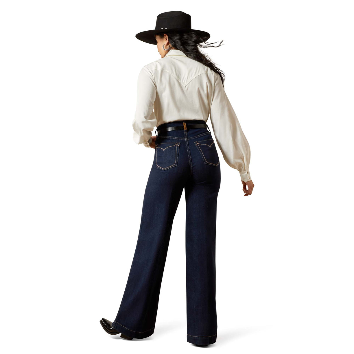 Person wearing a white shirt, dark blue jeans, and a black hat on a white background