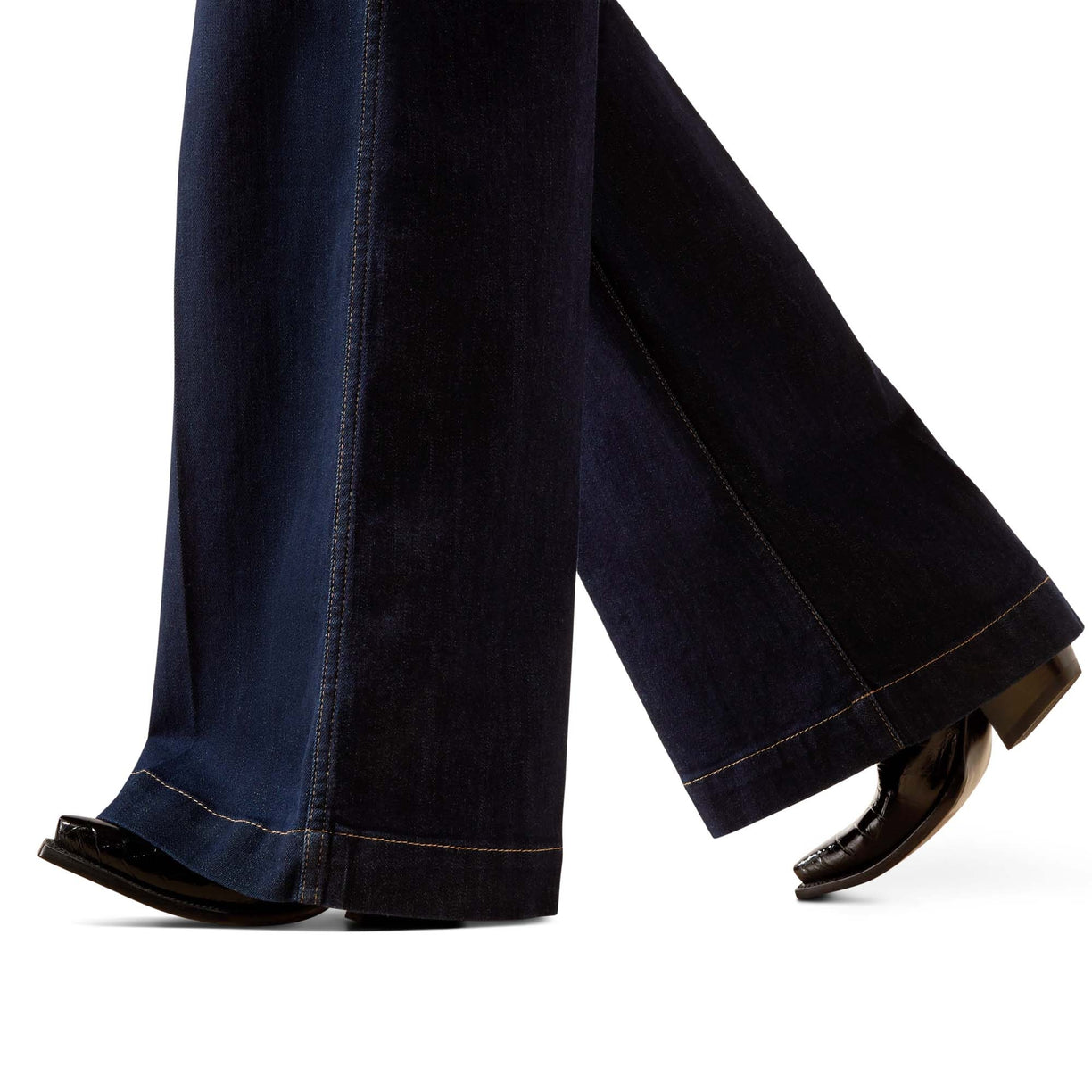 Dark blue jeans being worn on a white background