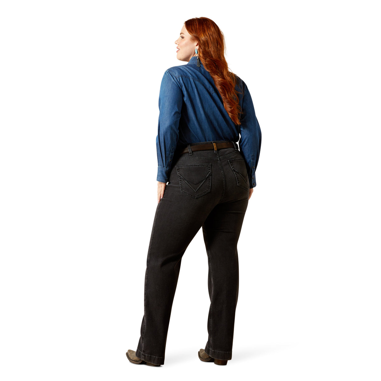 Woman wearing a blue shirt and black pants on a white background