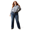 Woman wearing a checkered shirt and blue jeans on a white background