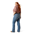 Woman wearing blue jeans and a plaid shirt on a white background