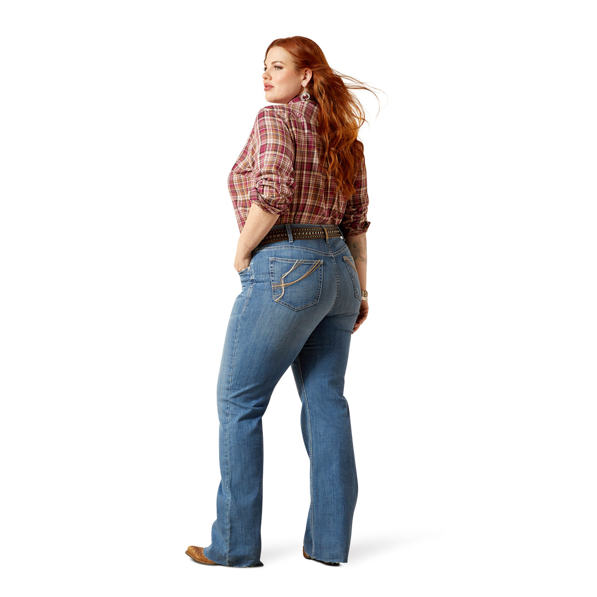 Woman wearing blue jeans and a plaid shirt on a white background