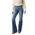 Person wearing blue jeans and a beige shirt on a white background