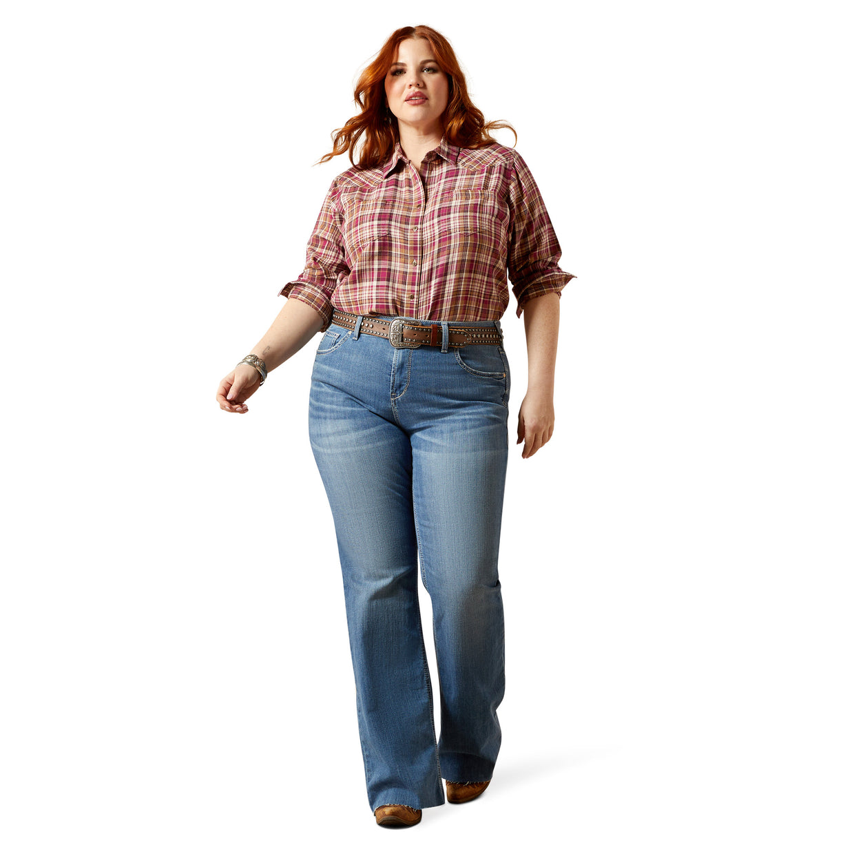 Woman wearing a plaid shirt and blue jeans on a white background