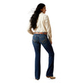 Woman wearing blue long leg  denim jeans belt loops and a cream shirt on a white background