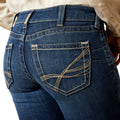 Close-up of blue jeans with a focus on the back pocket.