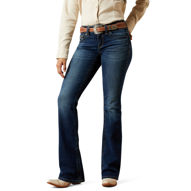 Person wearing blue jeans with a white background