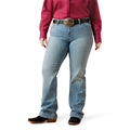 Person wearing blue jeans and a red shirt with a white background
