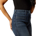 Blue jeans worn by a person on a white background