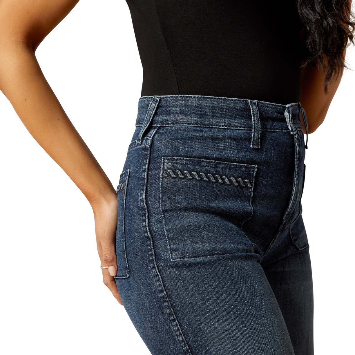 Blue jeans worn by a person on a white background