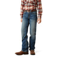 Person wearing blue jeans and a plaid shirt on a white background