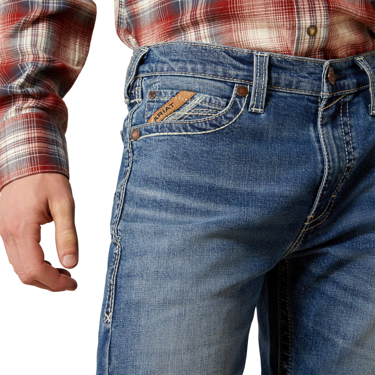Close-up of blue jeans with a plaid shirt on a white background