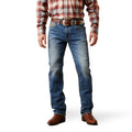 Person wearing blue jeans and a plaid shirt on a white background