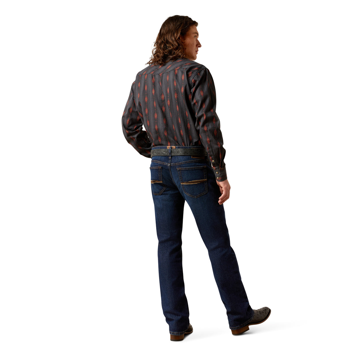 Person wearing a patterned shirt and jeans on a white background