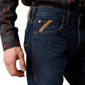 Close-up of blue jeans with a brand logo on a white background