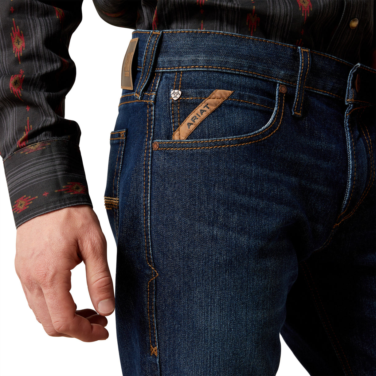 Close-up of blue jeans with a brand logo on a white background