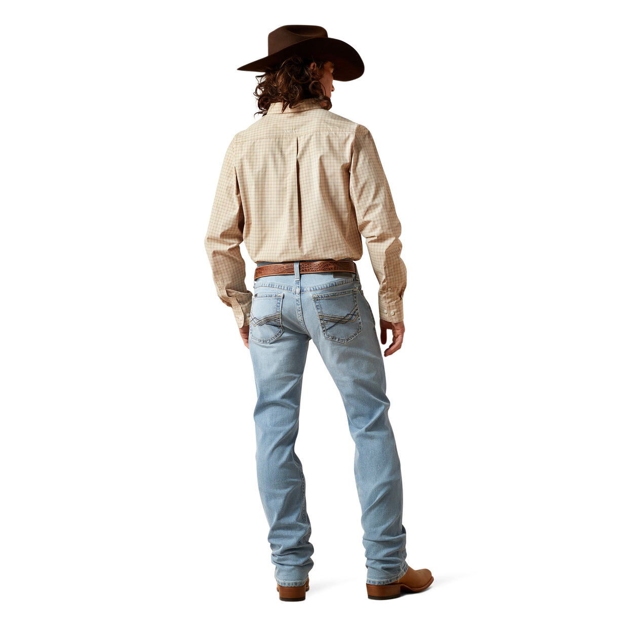 Person wearing a beige shirt, light blue jeans, and a brown hat on a white background