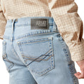 Light blue jeans with Ariat logo on the back pocket, worn by a person.