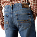 Blue jeans with Ariat logo on a white background
