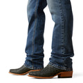 Blue jeans and brown cowboy boots on a white background