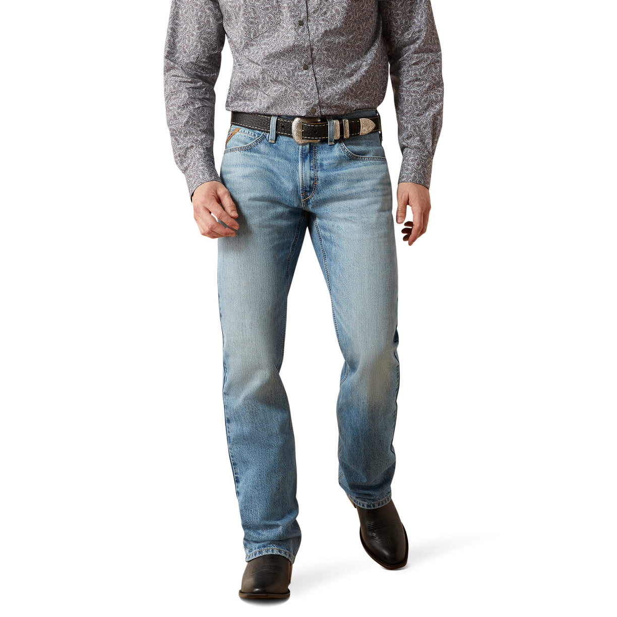 Person wearing light blue jeans and a patterned shirt on a white background