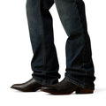Dark blue jeans and brown boots on a white background