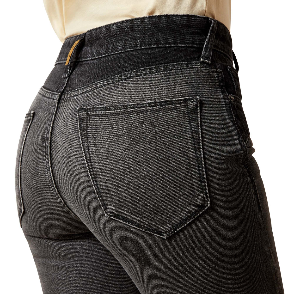 Black jeans with a focus on the back pocket on a white background