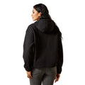 Person wearing a black hoodie from behind on a white background