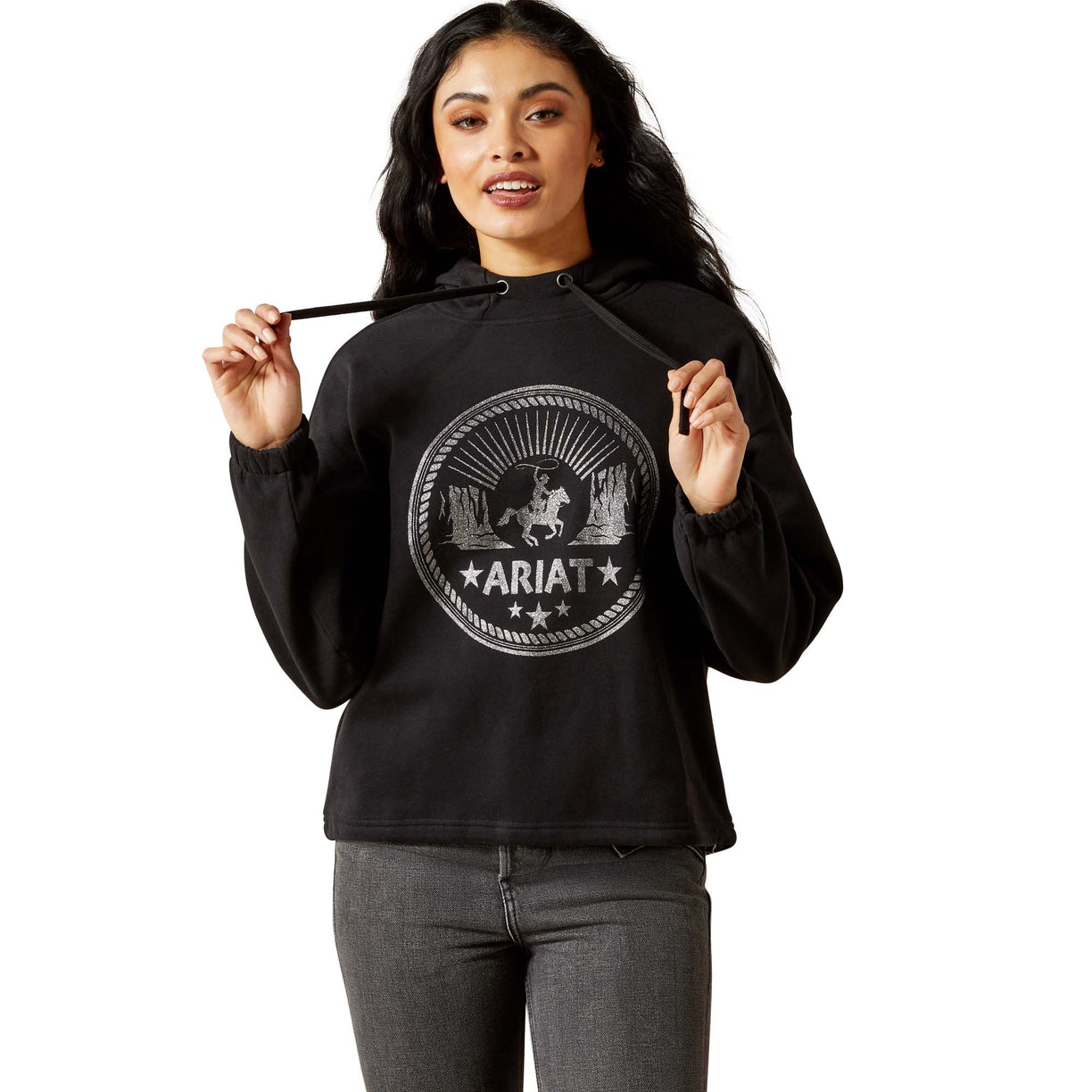 Woman wearing a black hoodie with Ariat logo on a white background