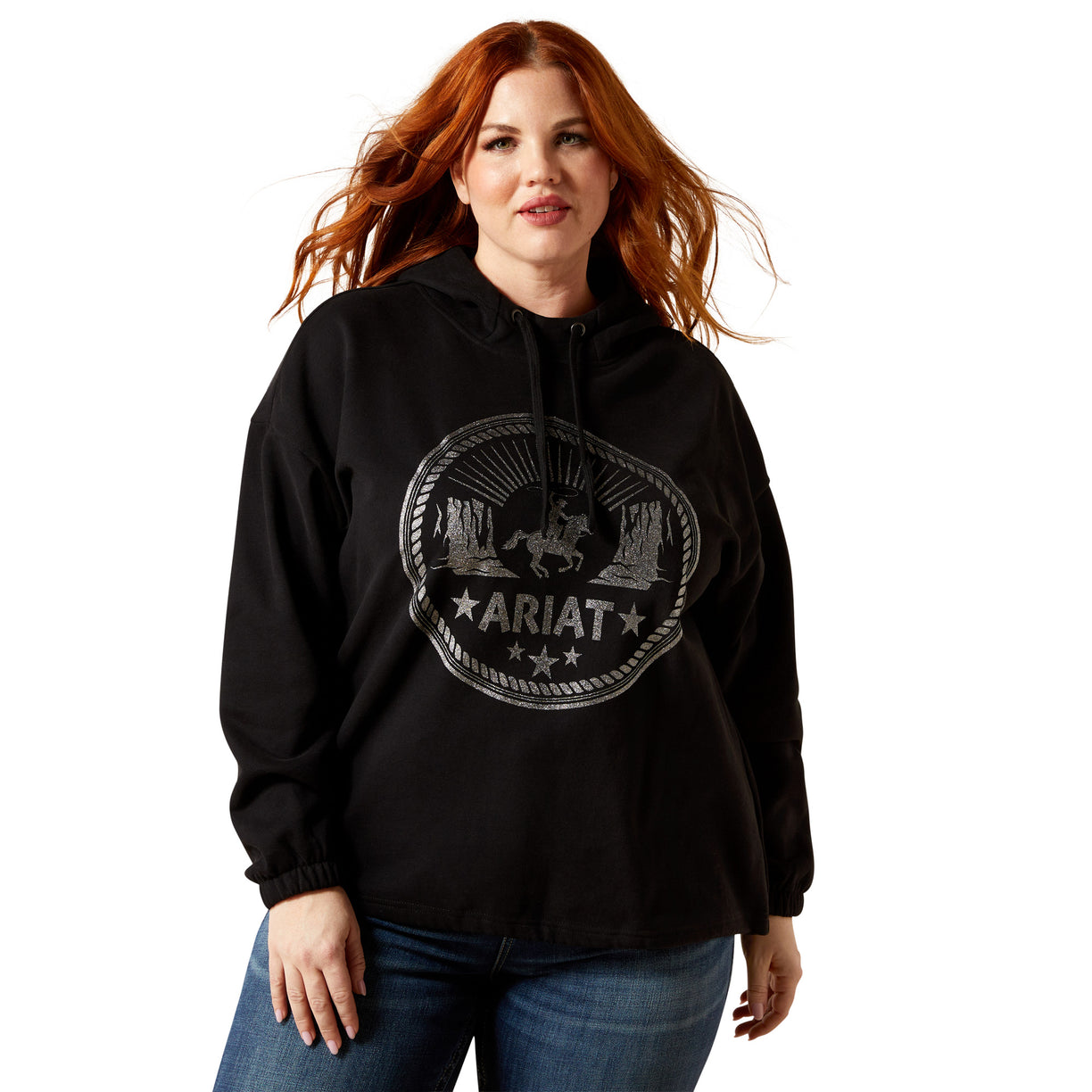 Woman wearing a black hoodie with Ariat logo on a white background