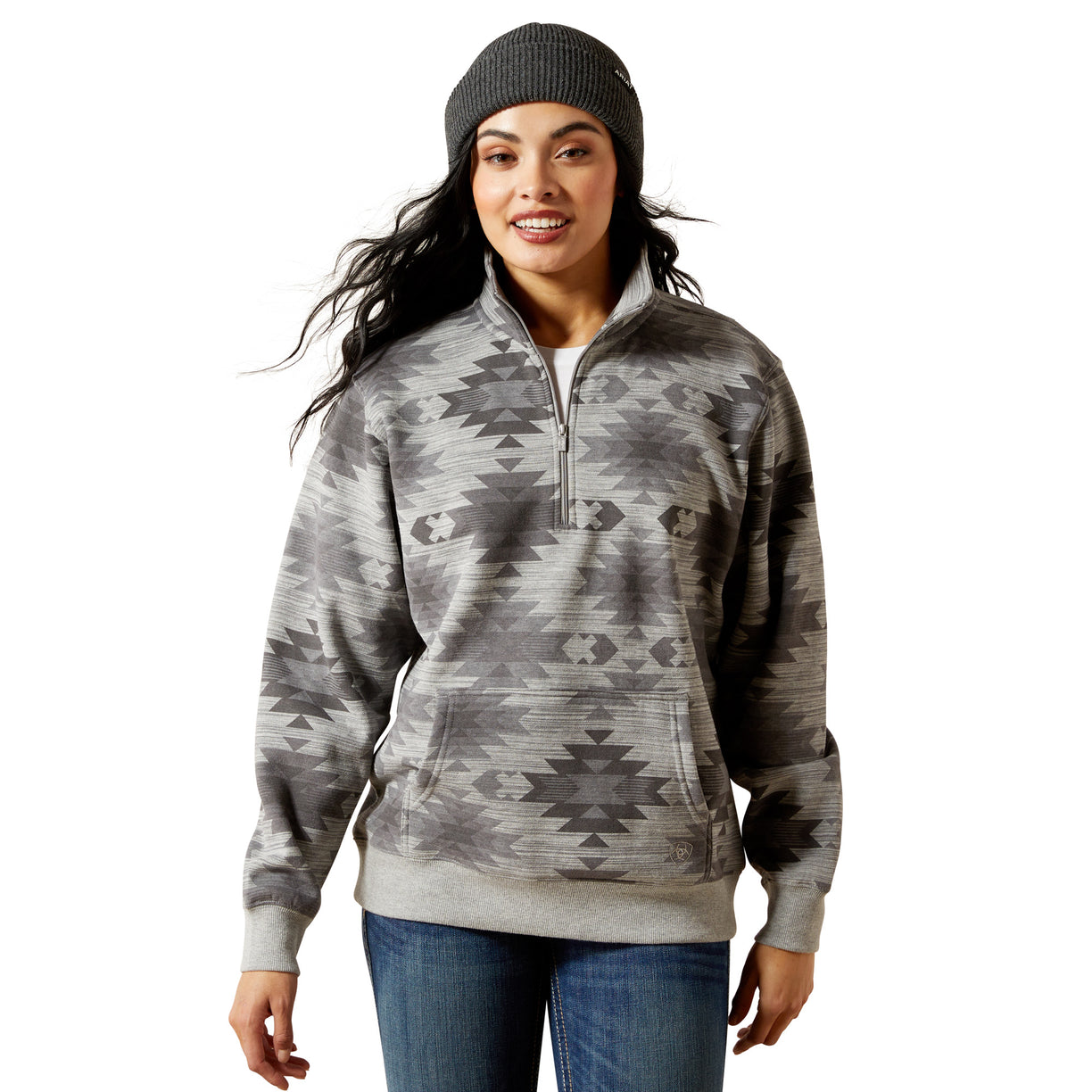 Woman wearing a gray patterned pullover with a white background