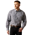 Man wearing a gray patterned button-up shirt and black pants on a white background