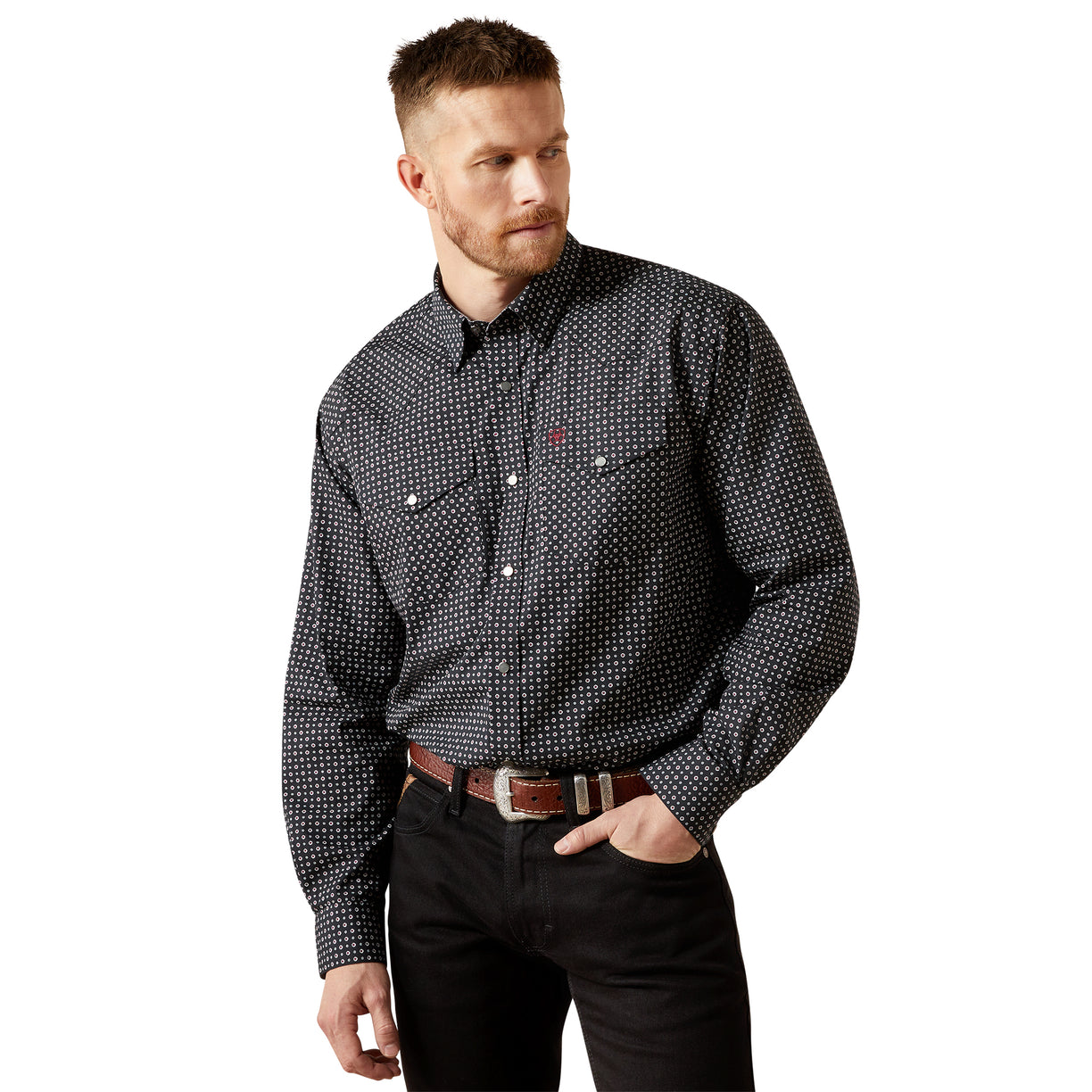 Man wearing a black patterned shirt and black pants on a white background