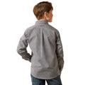 Child wearing a patterned shirt on a white background