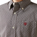 Close-up of a patterned shirt with a red logo on the chest.