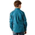Child wearing a blue patterned shirt on a white background