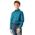Young boy wearing a teal patterned shirt and jeans on a white background
