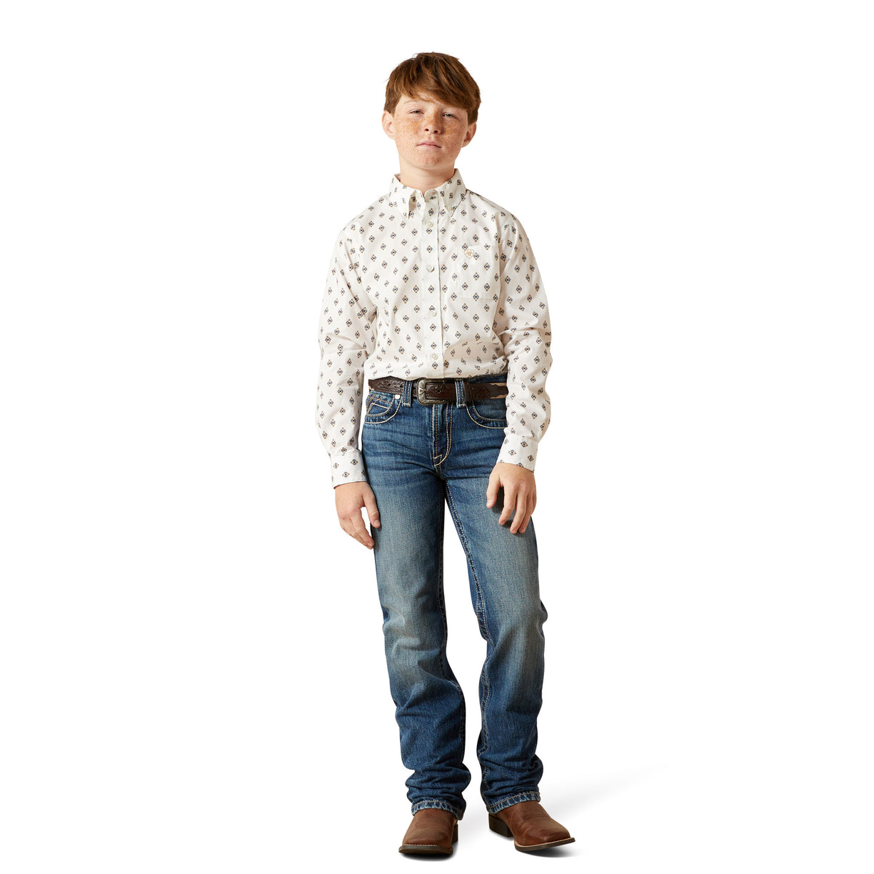 Young boy wearing a patterned shirt and jeans on a white background