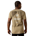 Person wearing a beige t-shirt with Ariat logo and design on the back