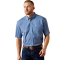 Blue micro-check short-sleeve shirt with chest pocket and logo detail - the Ariat Wrinkle Free Case Classic Fit Shirt, worn by a man with jeans