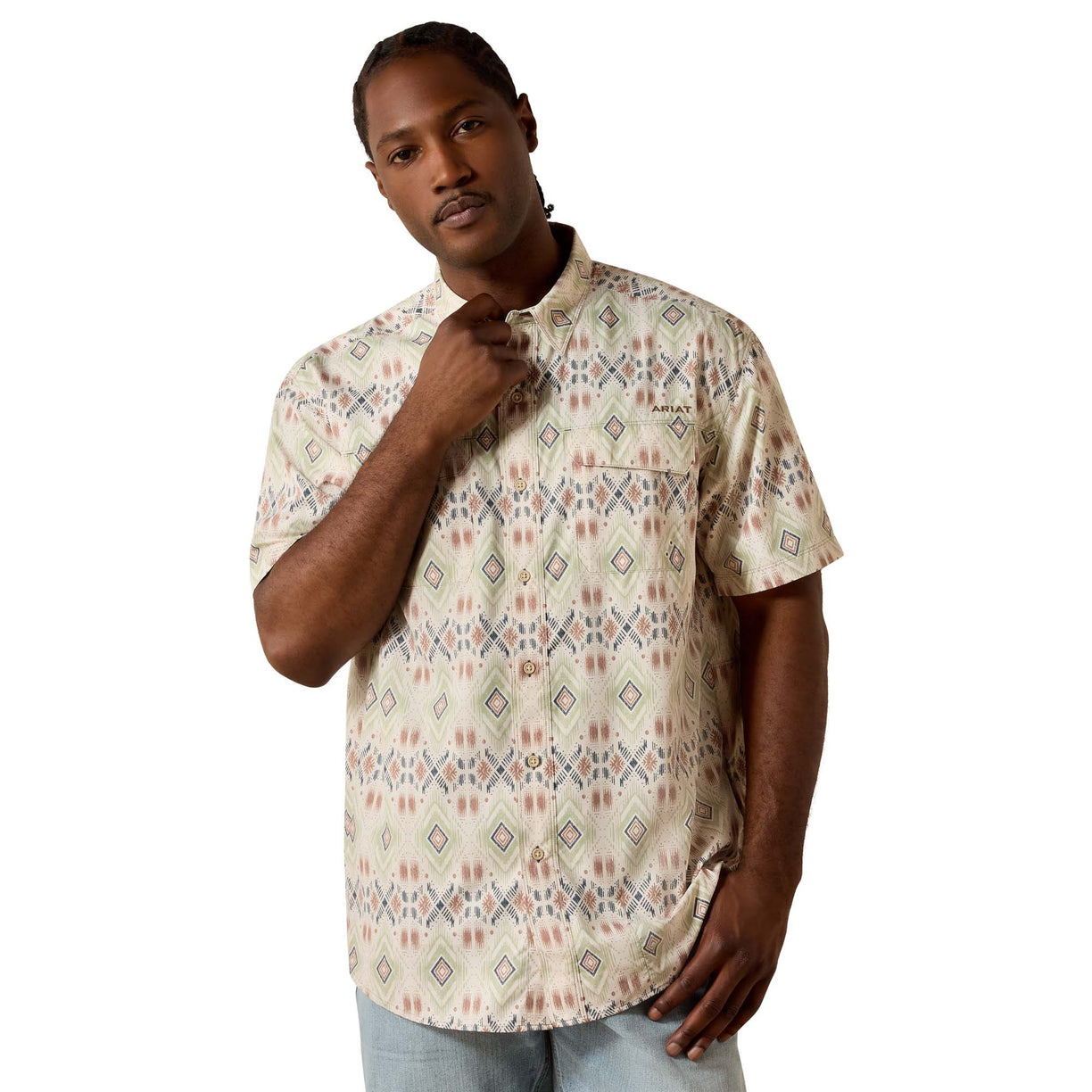 The Printed VentTEK Outbound Classic Fit Shirt in a tan aztec diamond print, short-sleeve with chest pocket, on a man styled with light denim.